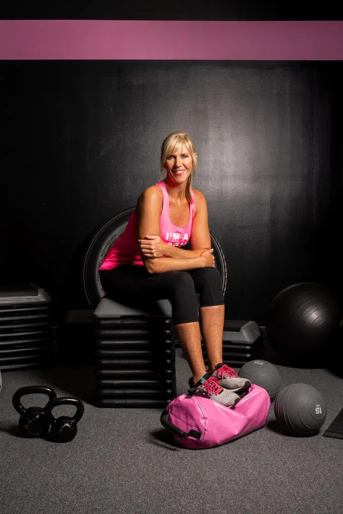 A Bad Girl Fitness coach seated in the studio, ready for a one-on-one personal training session